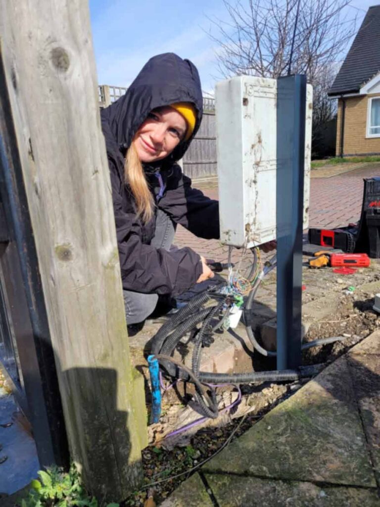 gate engineer repairing a gate control board and wiring as part of emergency gate repairs